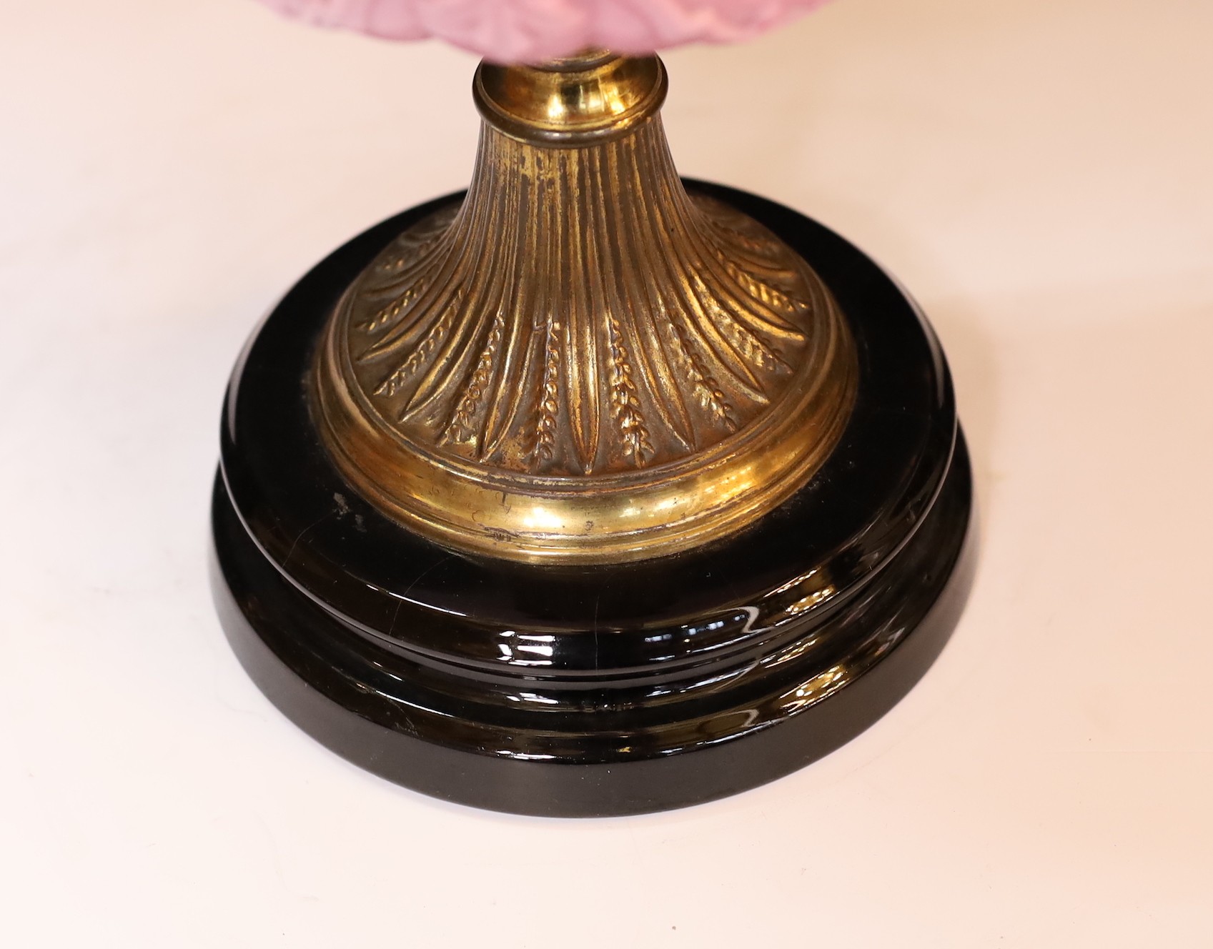 A late Victorian brass and pink opaque glass oil lamp with tinted frosted shade, height overall 56cm